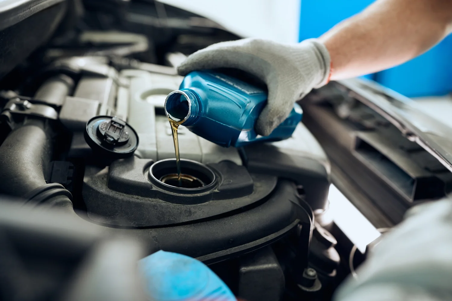 Technician checking engine oil level on a dipstick